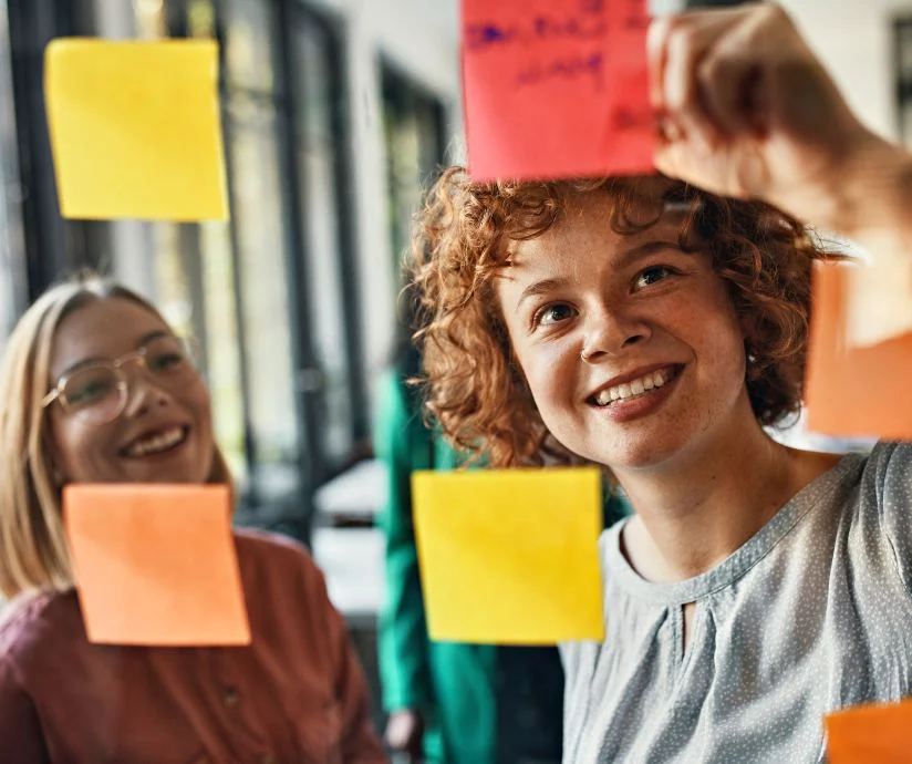 two women using sticky notes